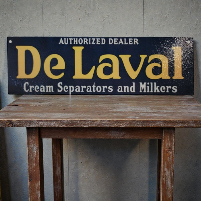 Vintage-style sign for DeLaval cream separators and milkers on a wooden table.