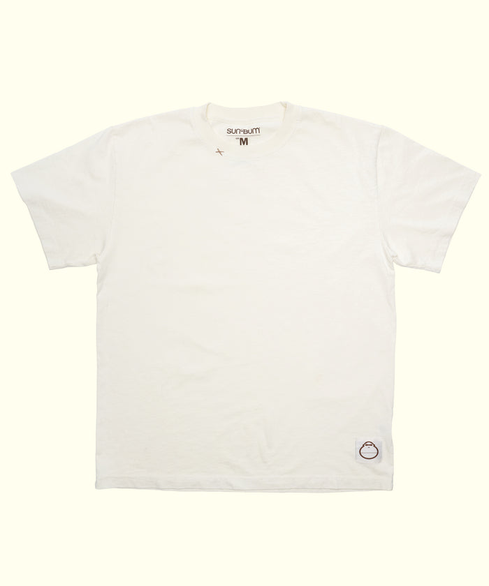 Original Tee (Cream), a 100% cotton short sleeve shirt laid flat with a small logo patch