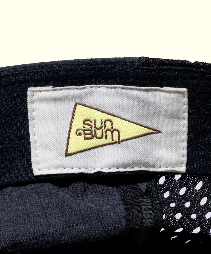 Close-up of a 'Sun Bum' label on a product with a white background