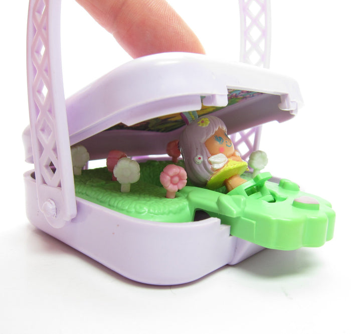Primrose Fairy Charmkins doll in Magic Garden Pocket Pops case